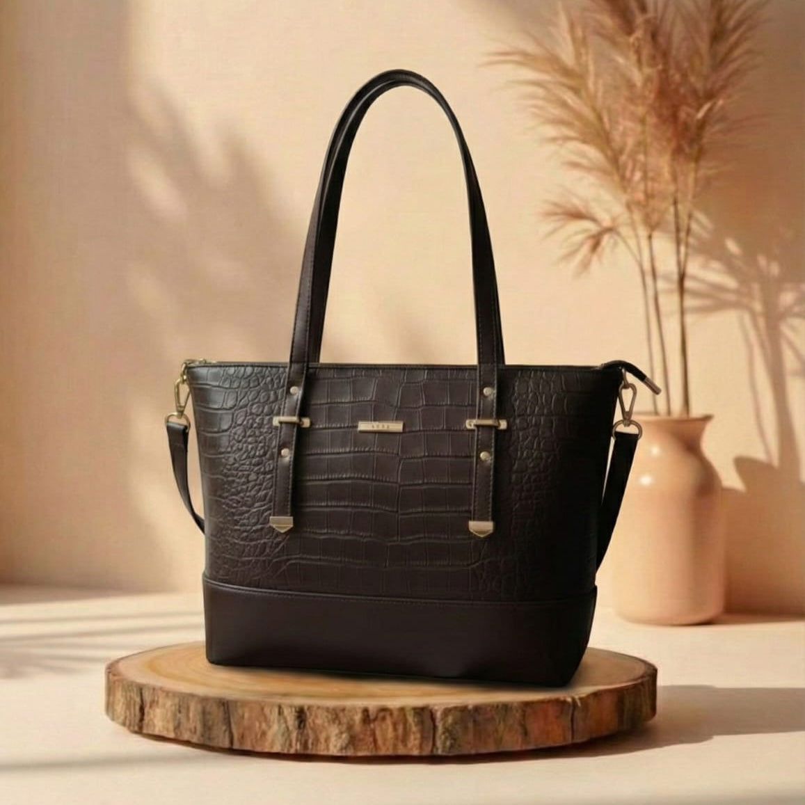 Black handbag on a wooden stand with a neutral background