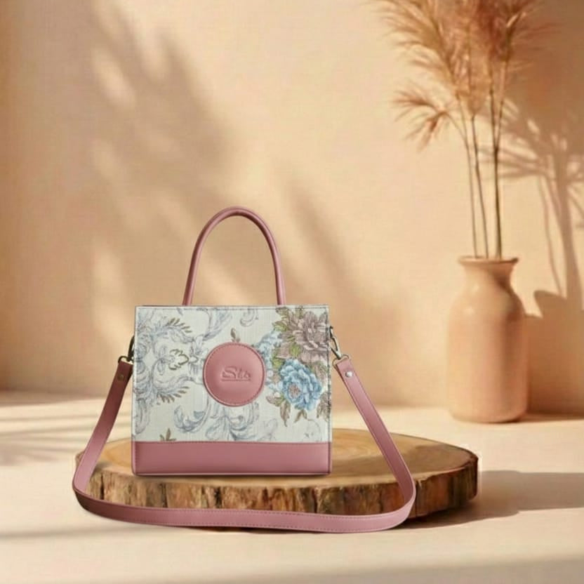 pink Floral handbag with pink accents on a wooden stand against a beige background