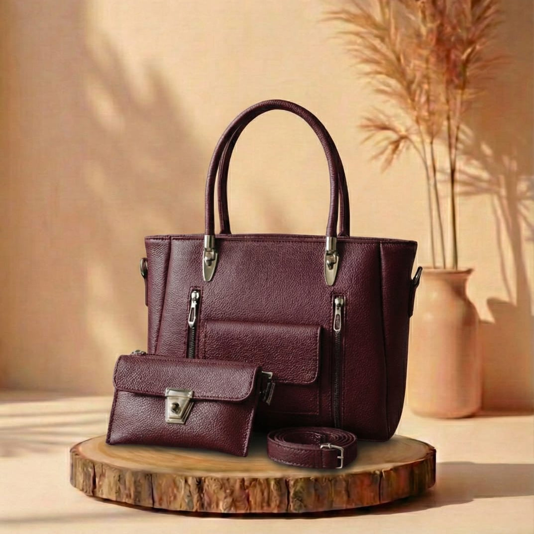 burgundy handbag and matching pouch on a wooden stand with a beige background