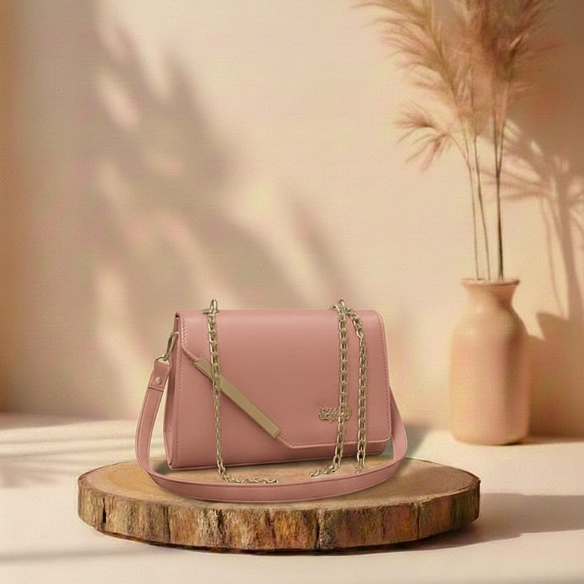 Pink handbag on a wooden platform with a vase and plants in the background