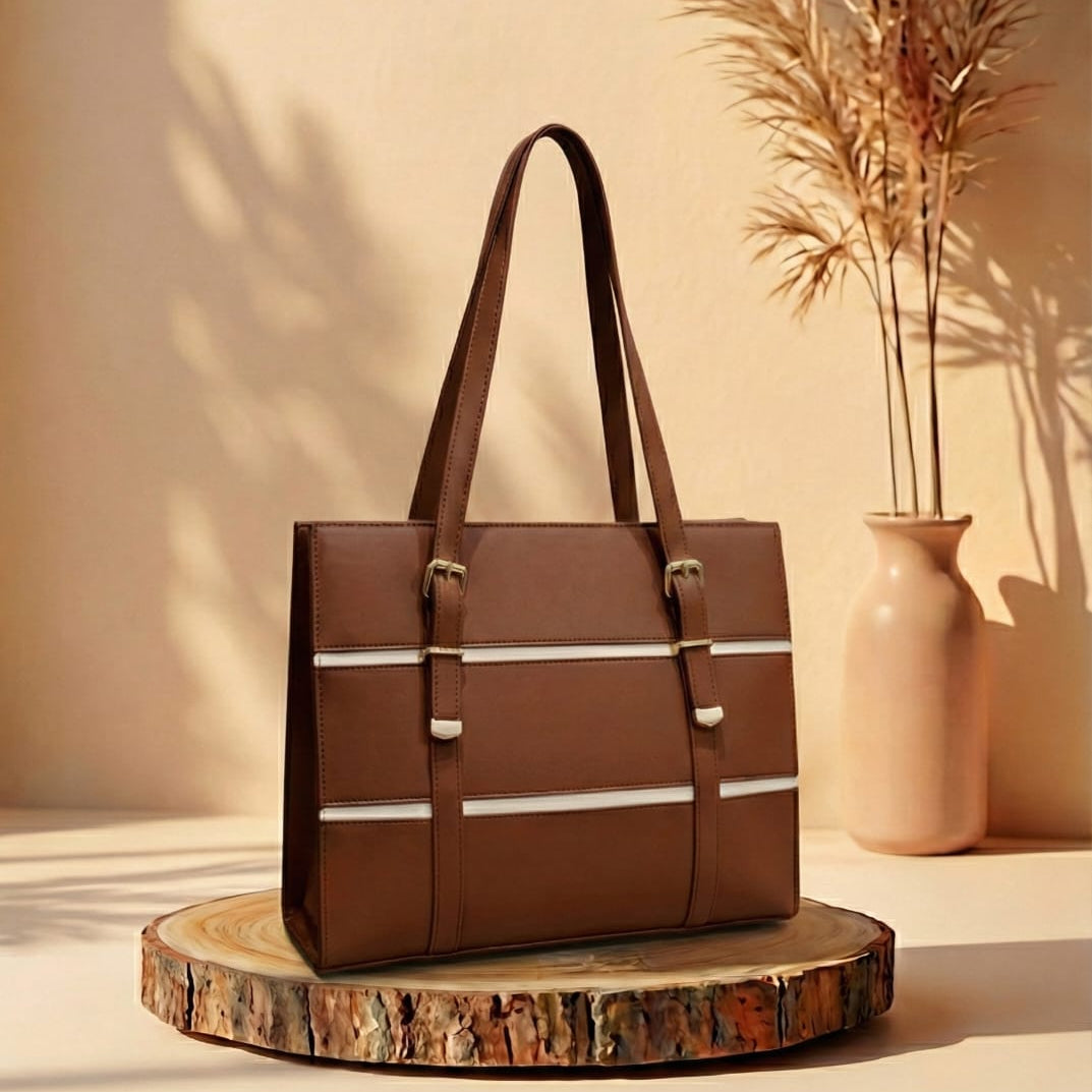 Brown handbag on a wooden stand with a vase and plants in the background