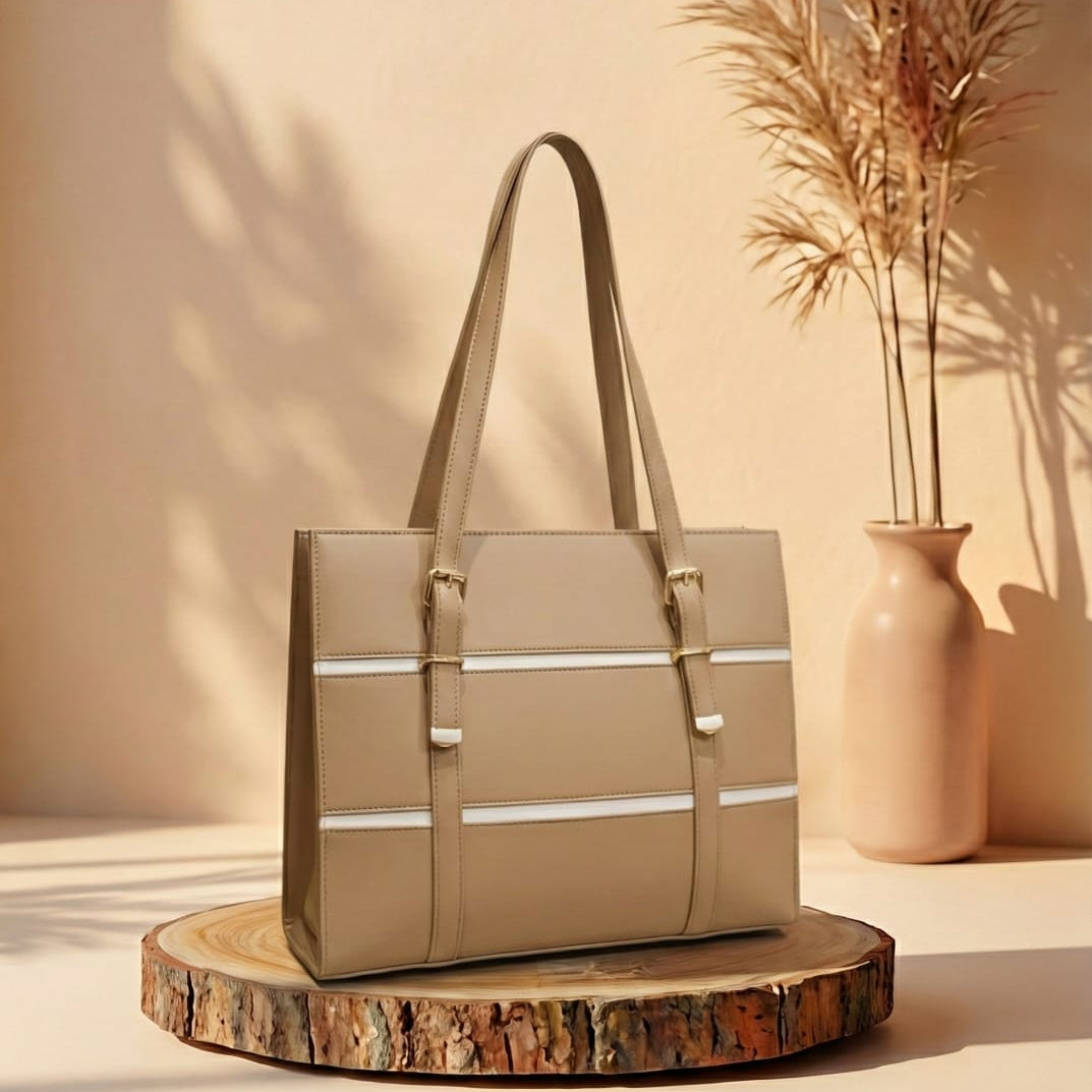 Beige handbag on a wooden stand with a vase and plants in the background