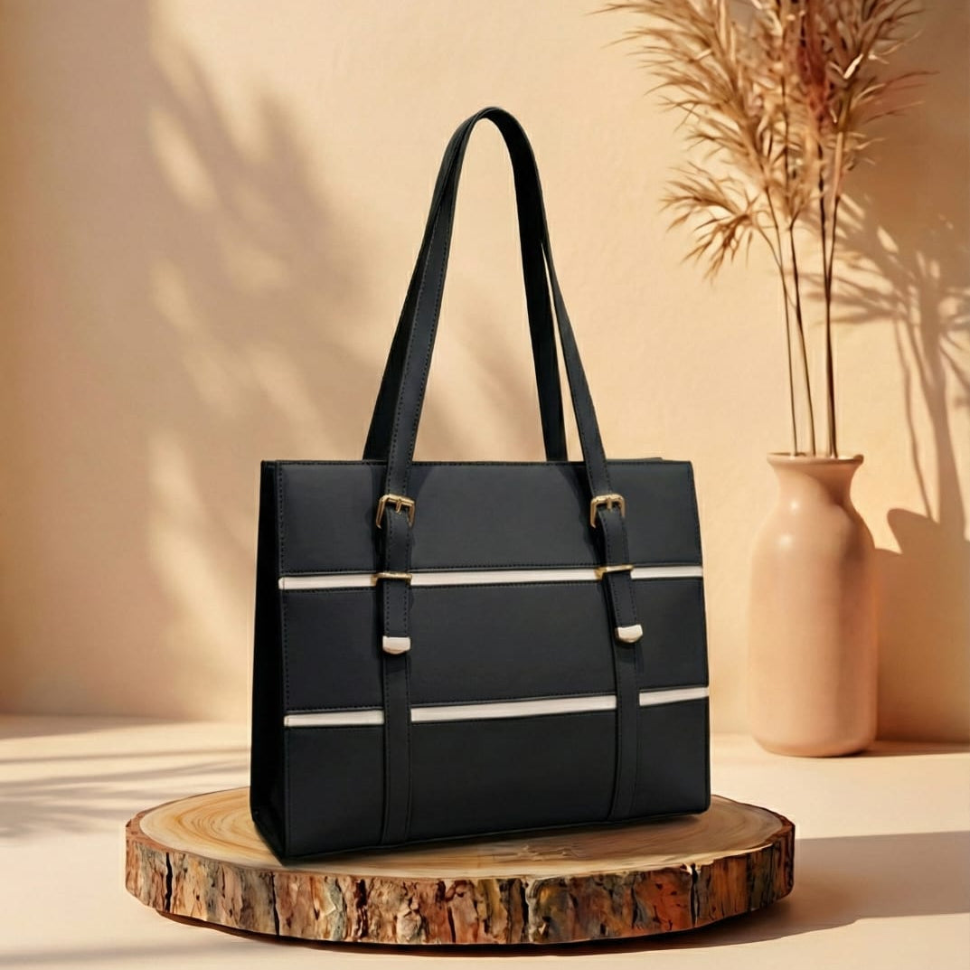 Black handbag with white stripes on a wooden stand against a beige background