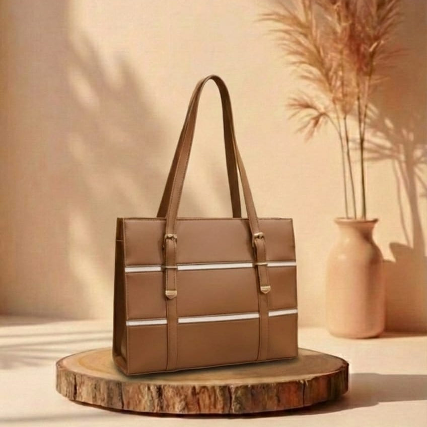 Bronze handbag on a wooden stand with a vase and plants in the background