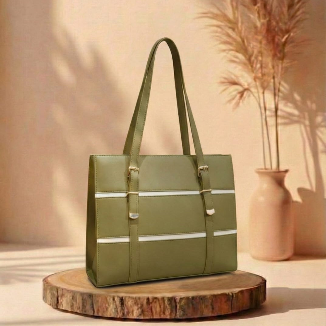olive Green handbag on a wooden stand with a vase and plants in the background