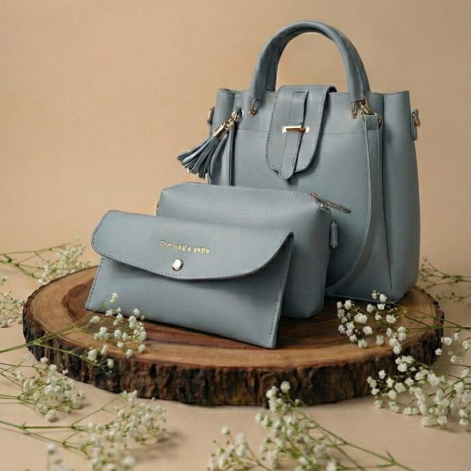 grey handbag and smaller pouch on a wooden stand with a beige background