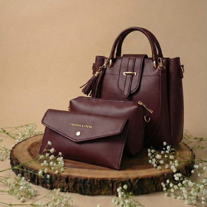 maaroon leather handbag on a wooden stand with a beige background