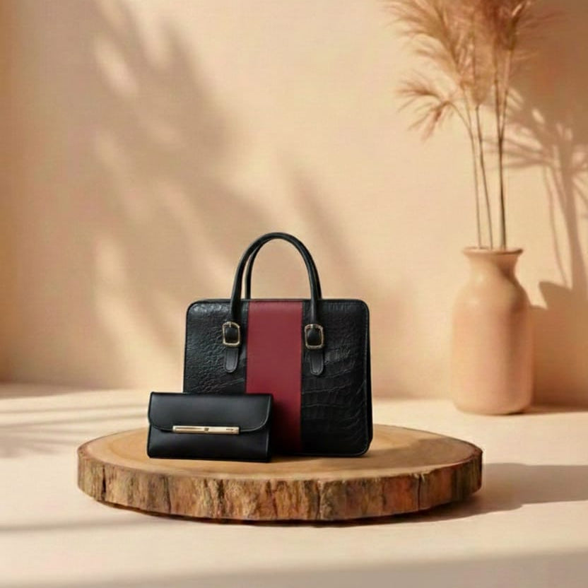 Black and maroon handbag on a wooden stand with a vase and plants in the background