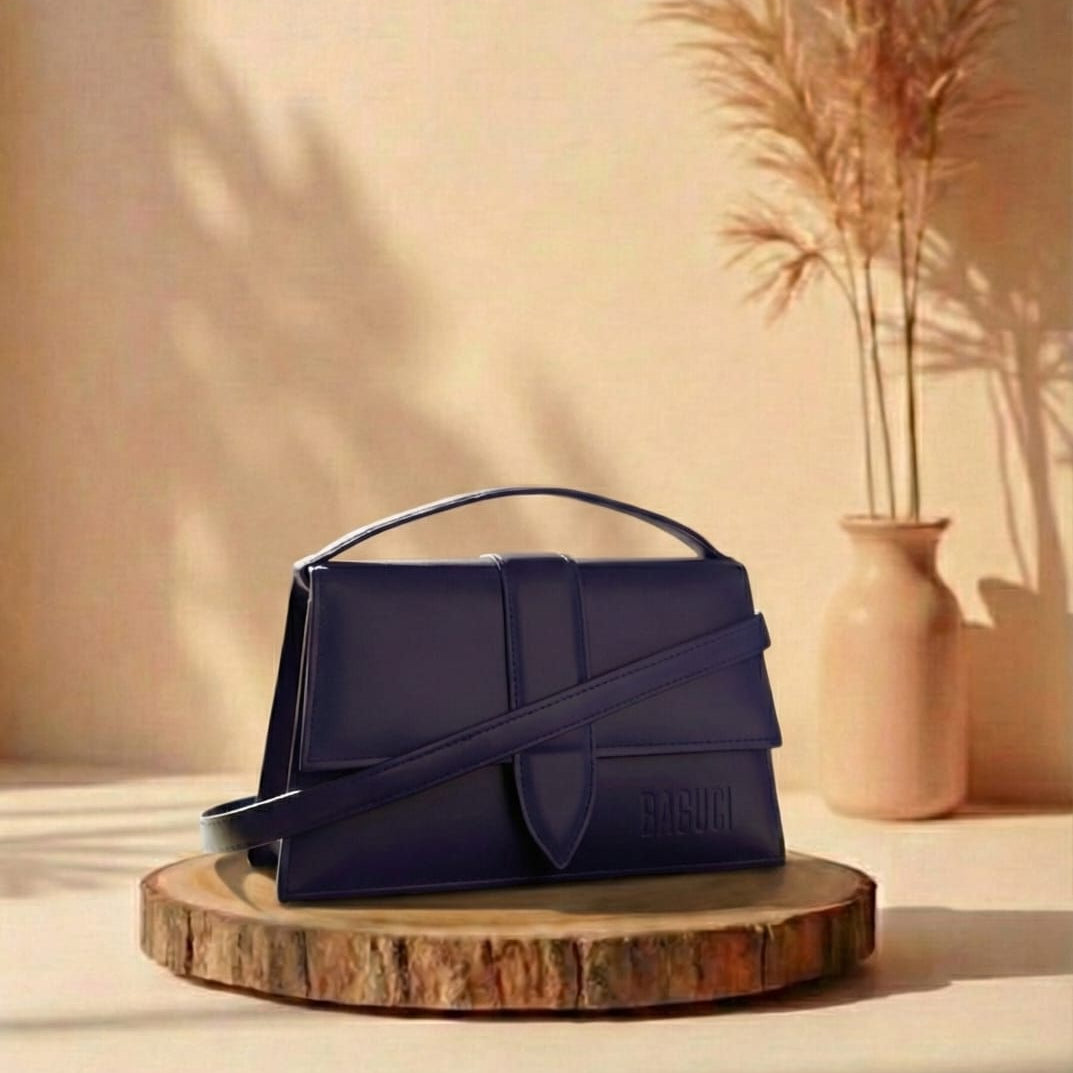 dark purple handbag on a wooden stand with a vase and plants in the background